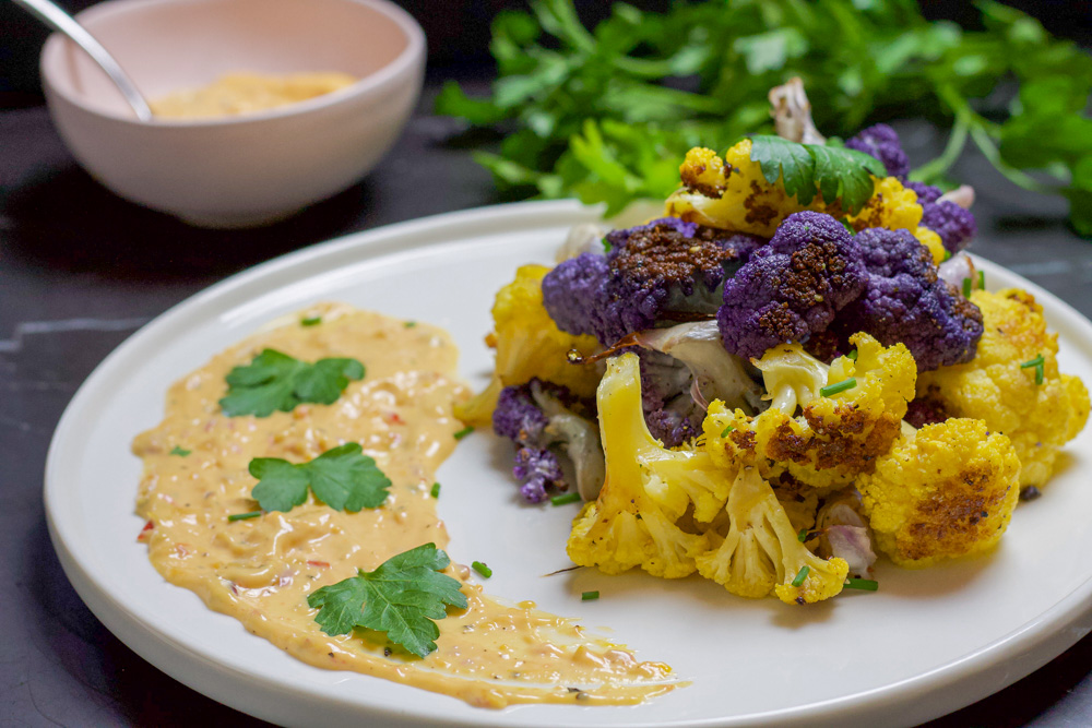 crispy cauliflower with Calabrian chili mayo and parsley on white plate