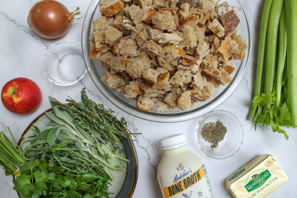 ingredients for stuffing: onion, salt, apple, herbs, sourdough bread, chicken broth, pepper, butter, and celery