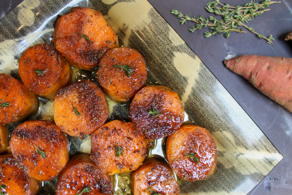 Twice ‘Baked’ Brown Sugar Spiced Sweet Potatoes on a serving plate with thyme