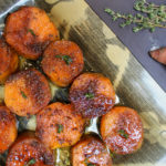 sweet potatoes on a serving plate with thyme