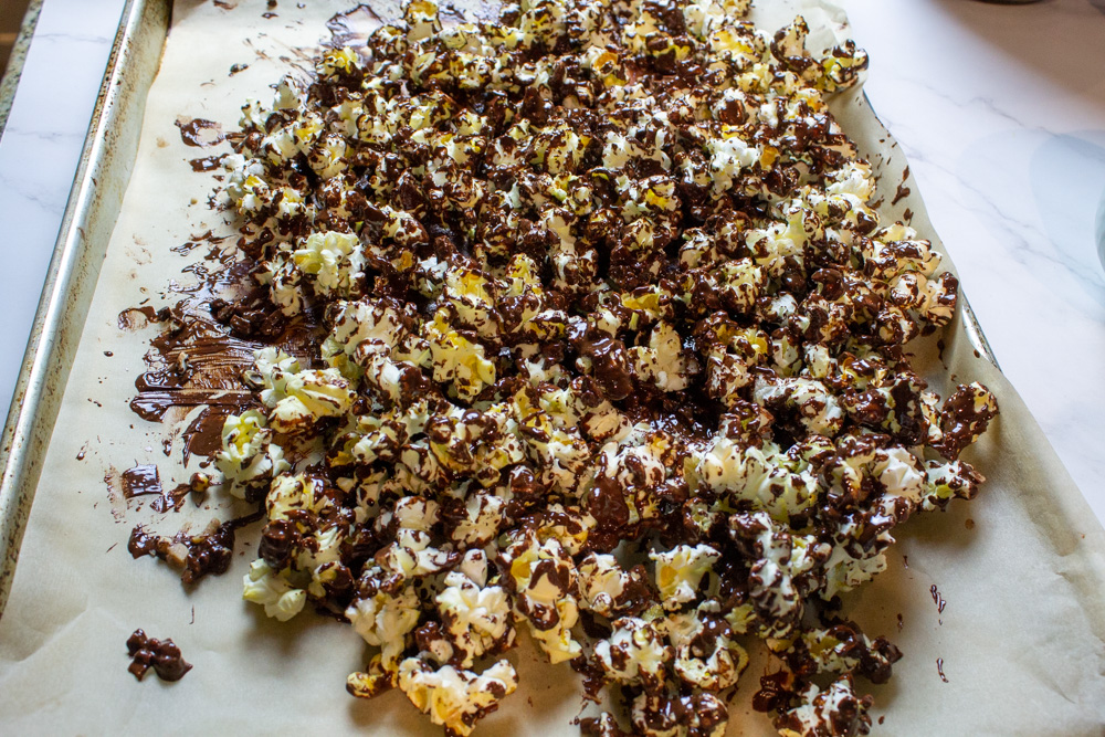 popcorn on parchment lined tray coated in chocolate