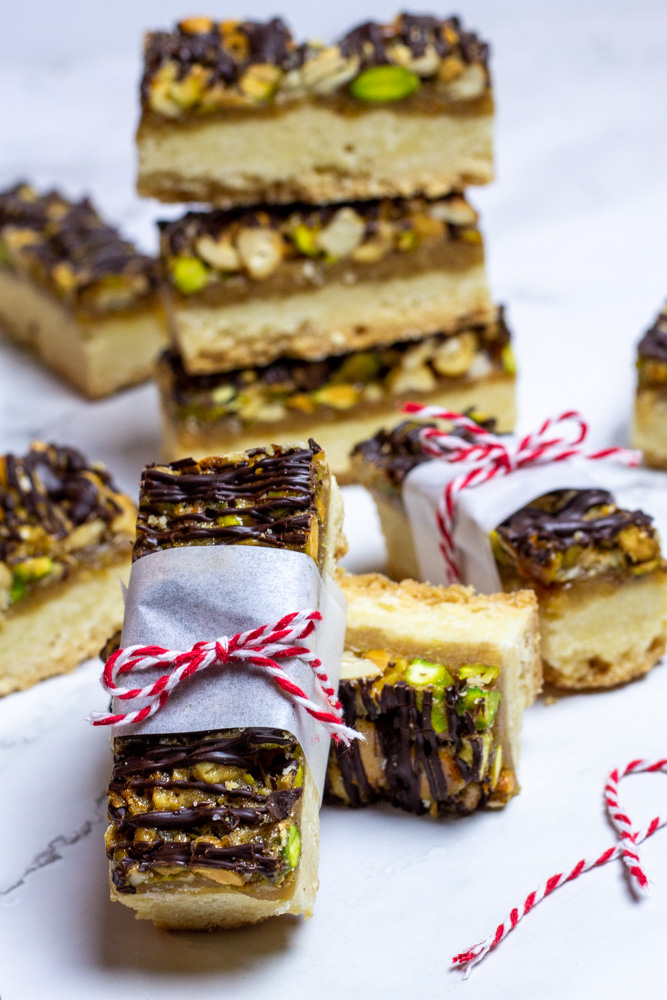 shortbread nut bars with chocolate drizzle wrapped in parchment with red baker's twine