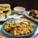 spicy rigatoni surrounded by other dishes