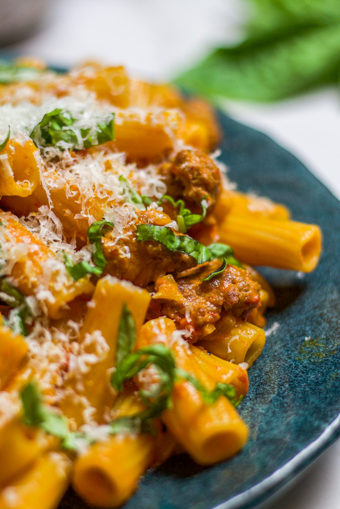 spicy sausage rigatoni topped with basil and parmesan