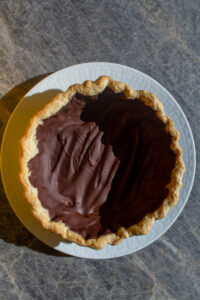 pie crust lined with chocolate after it hardens