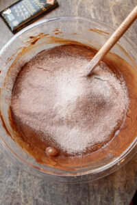mixing brownie batter for pumpkin brownies