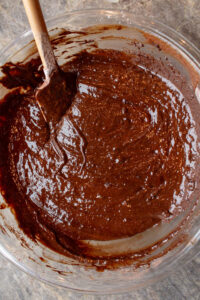 mixing brownie batter for pumpkin brownies