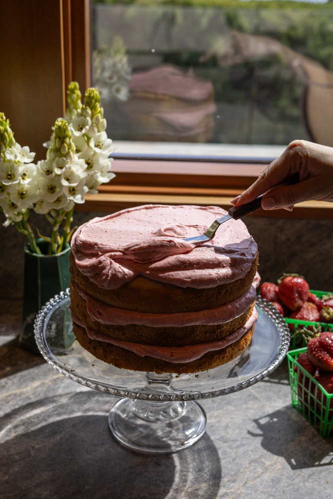 Strawberry Shortcake Cake being iced